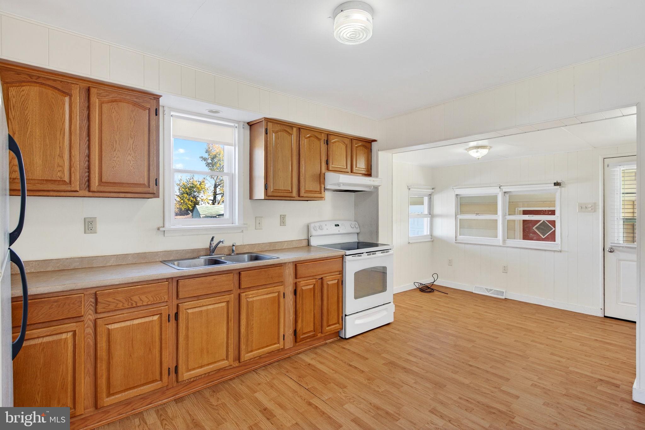 1705 Virginia Avenue Dover, PA 17315 - Photo 13 of 41 a large kitchen with wooden floors and white cabinets