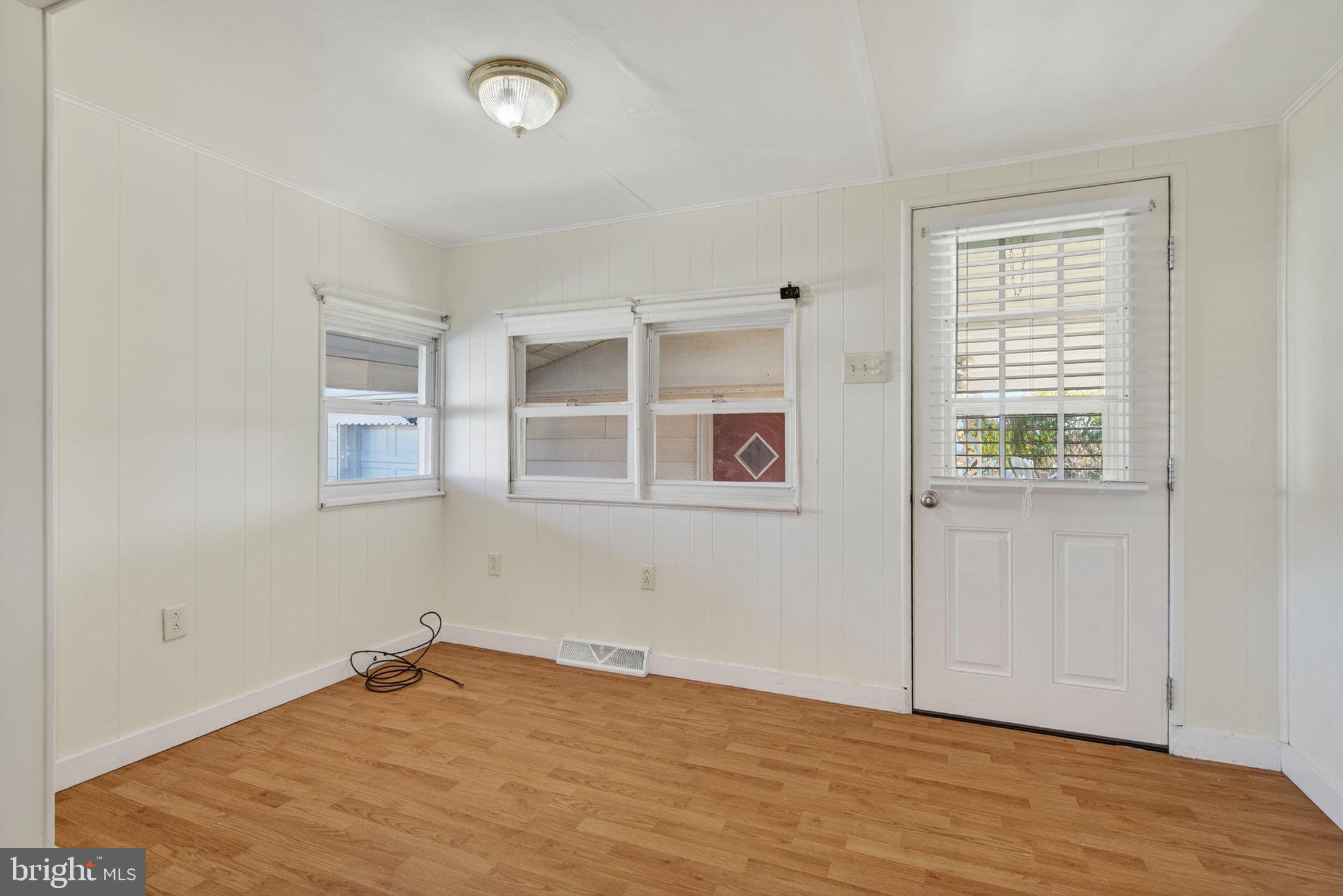 1705 Virginia Avenue Dover, PA 17315 - Photo 16 of 41 a view of an empty room with wooden floor and a window