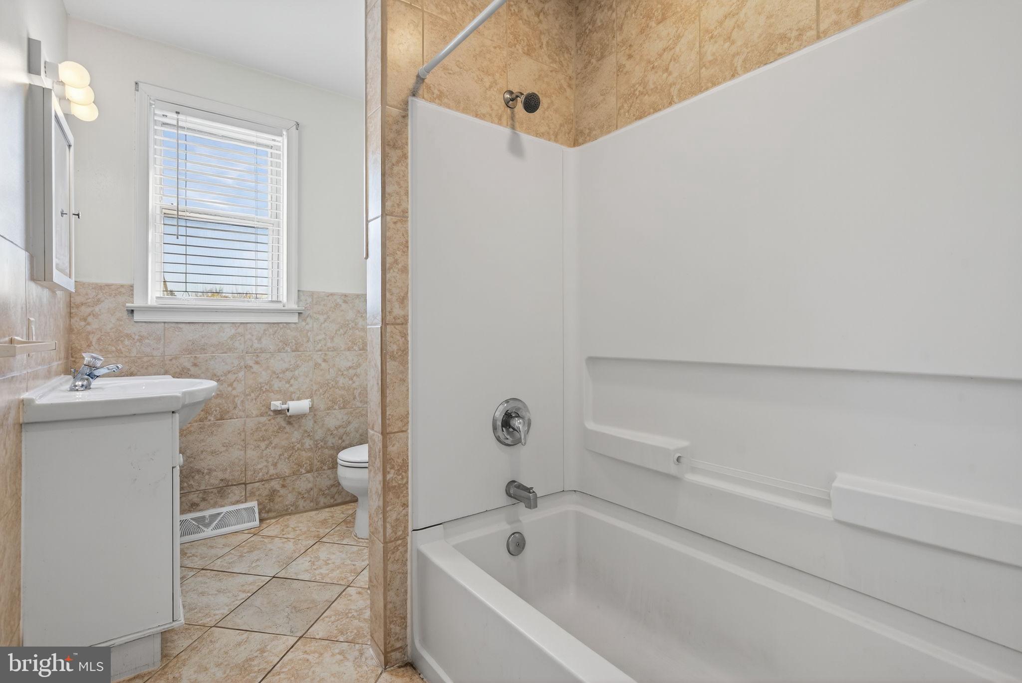 1705 Virginia Avenue Dover, PA 17315 - Photo 23 of 41 a bathroom with a bathtub and a shower
