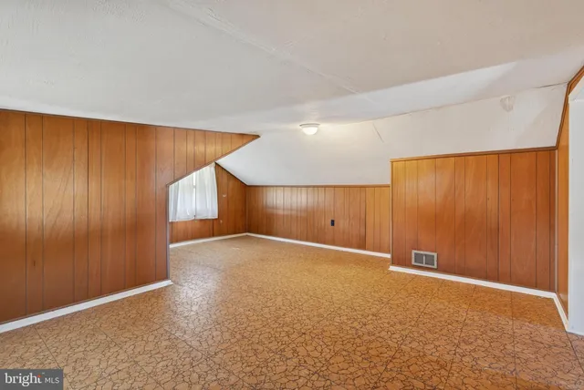 a view of an empty room with a wooden walls
