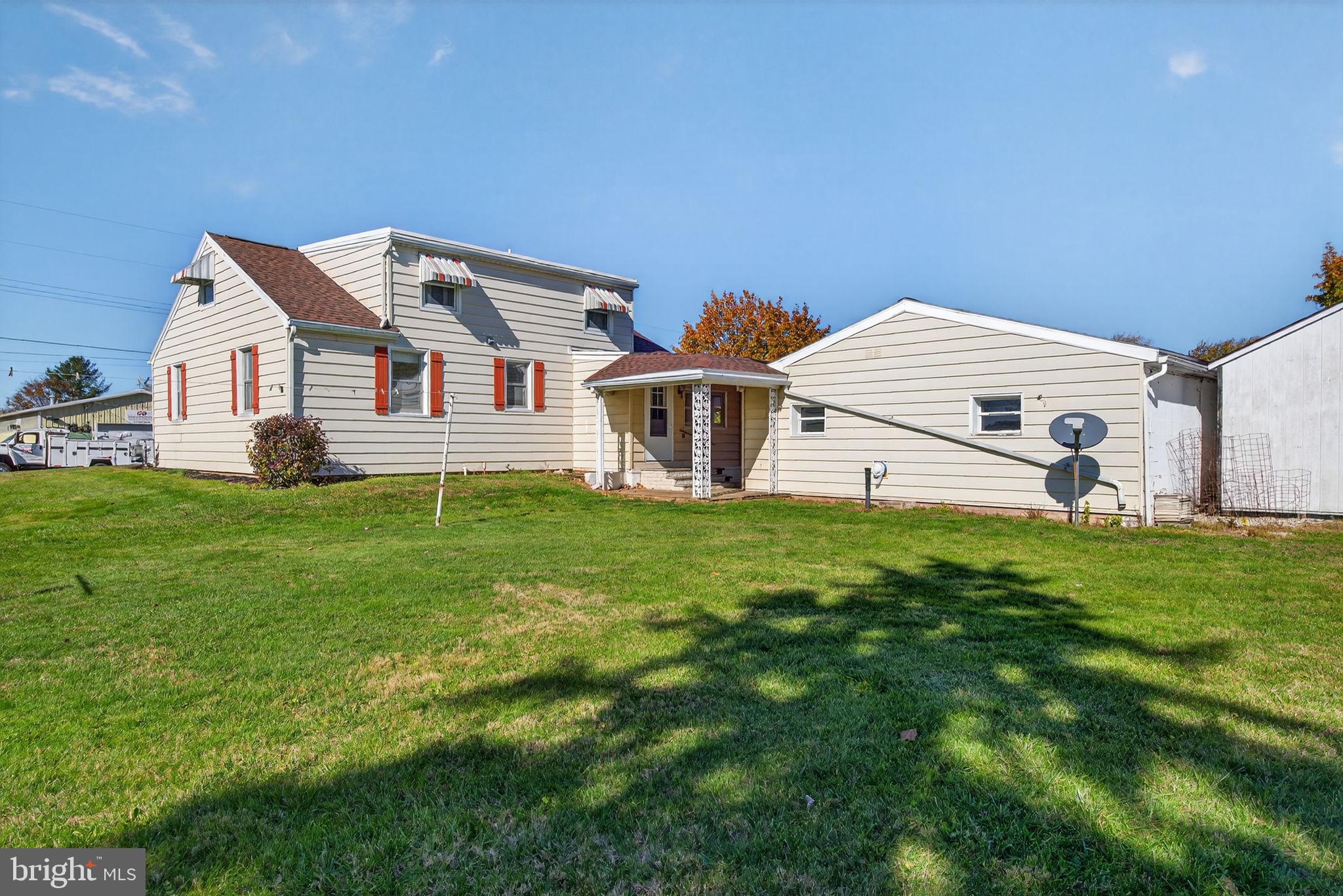 1705 Virginia Avenue Dover, PA 17315 - Photo 36 of 41 a front view of a house with a garden and yard