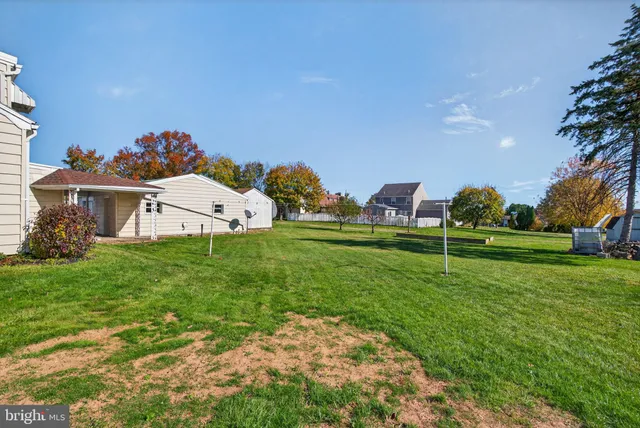 a view of a backyard with a garden and entertaining space