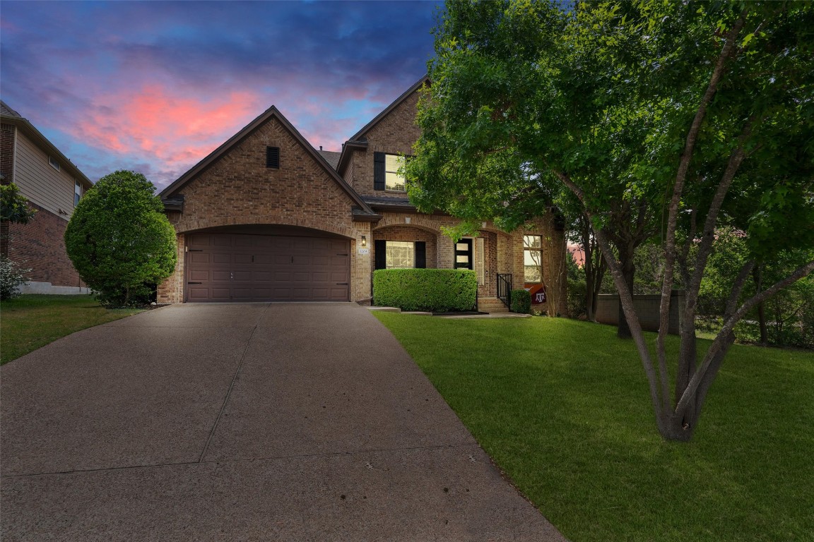 1209 Cassiopeia Way Austin, TX 78732 - Photo 1 of 1 a front view of a house with a yard