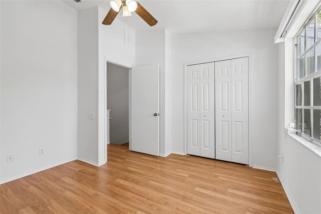 382 Countryside Key Boulevard Oldsmar, FL 34677 - Photo 28 of 58 an empty room with wooden floor closet and windows
