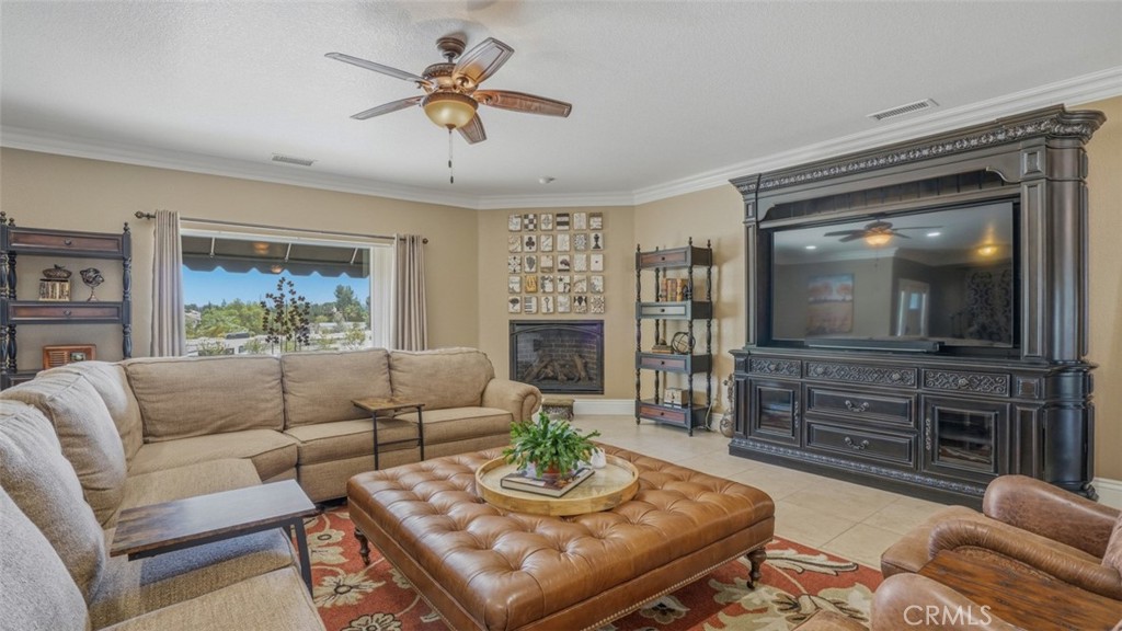16025 Perry Heights Drive Riverside, CA 92504 - Photo 34 of 105 Living Room With Cozy Fireplace and Gorgeous Entertainment Center