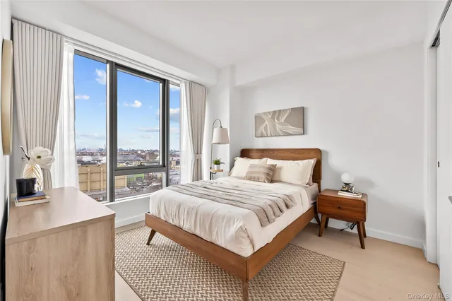 a bedroom with a large bed and a large window