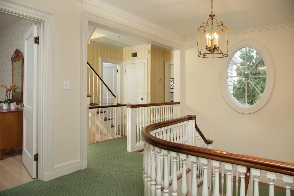 12 Carlton Road Newton, MA 02468 - Photo 8 of 12 a view of a hallway with windows stairs and a chandelier