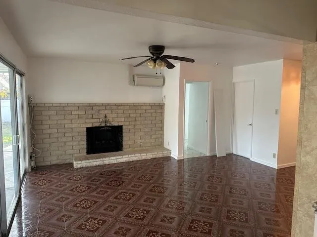 a view of empty room with a fireplace