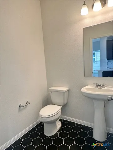a white toilet sitting next to a white sink