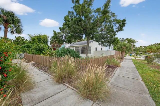 a view of a pathway with a wrought fence