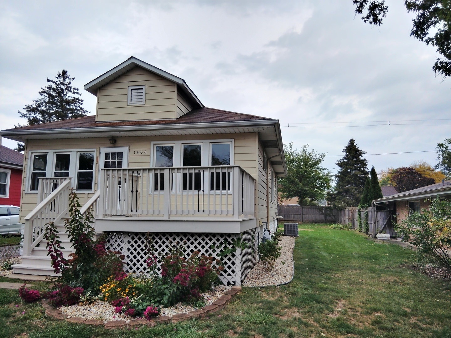 a front view of a house with a garden