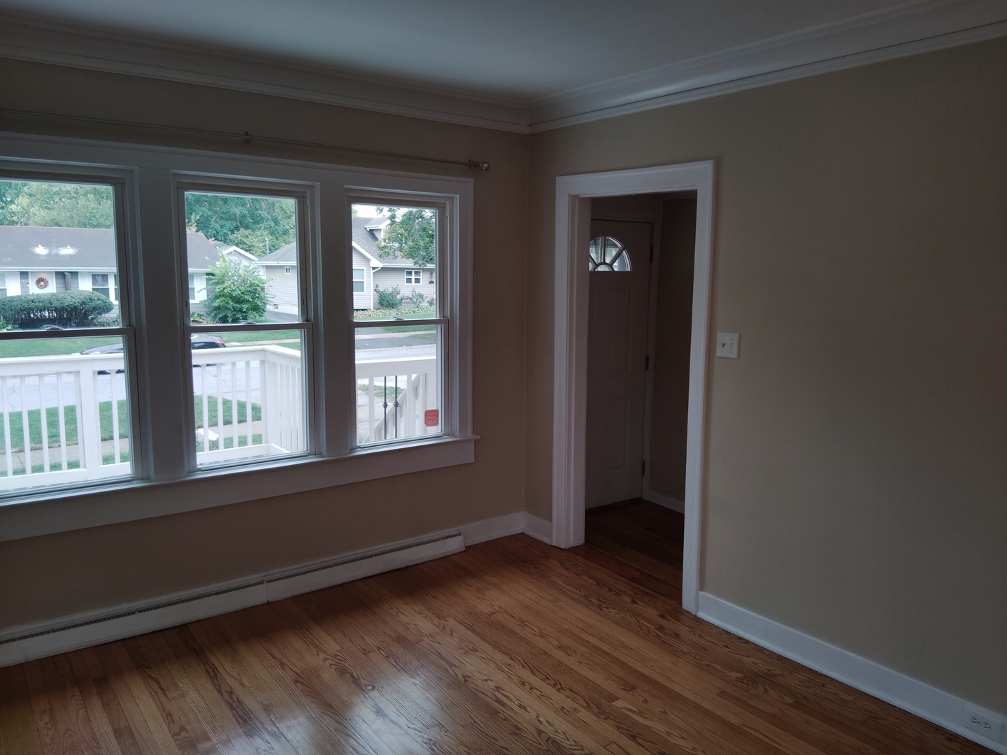 1406 Birch Road Homewood, IL 60430 - Photo 2 of 31 a view of an empty room with wooden floor and a window