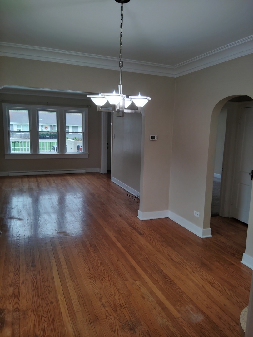 1406 Birch Road Homewood, IL 60430 - Photo 4 of 31 a view of a livingroom with wooden floor and a chandelier