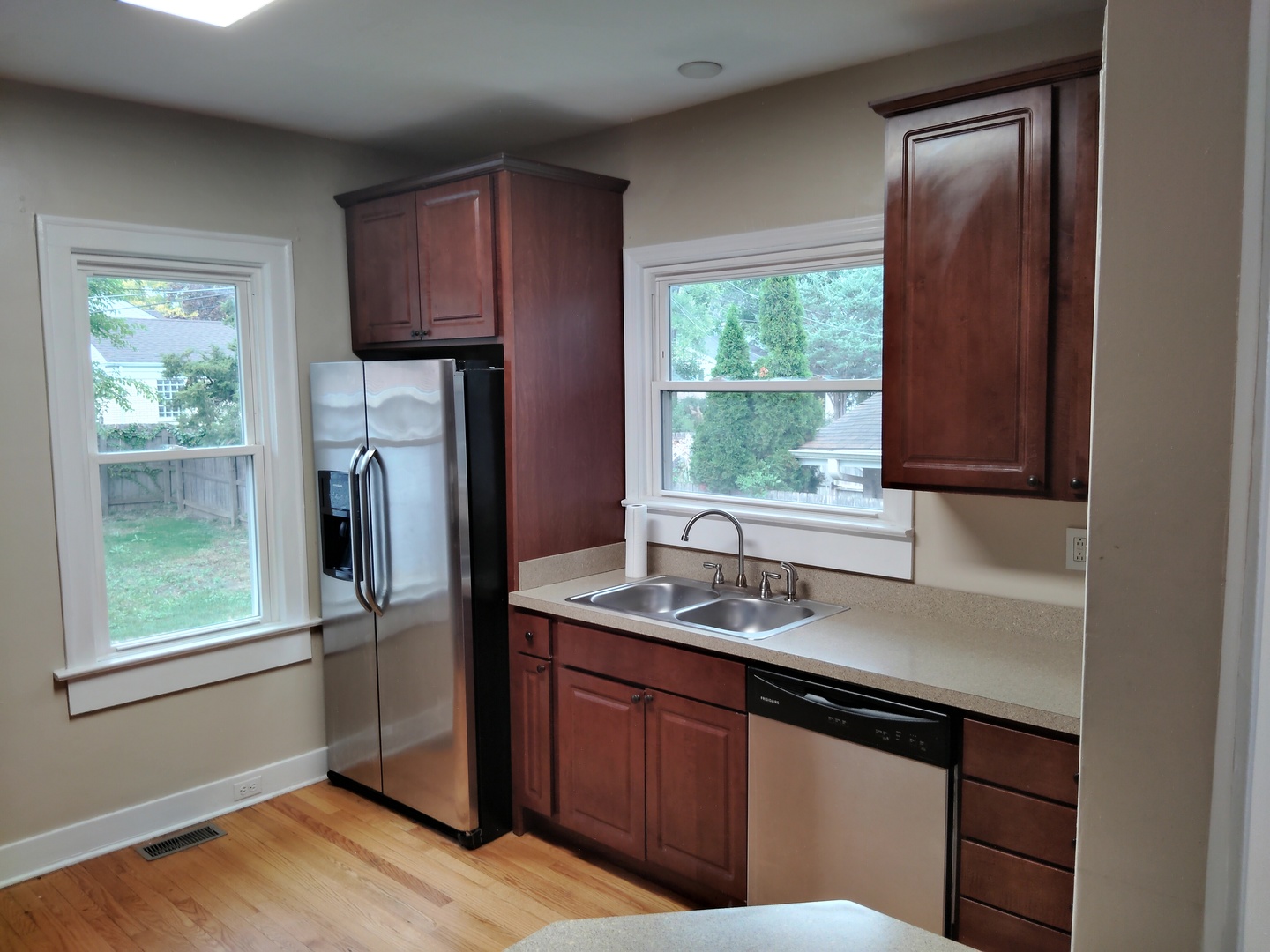 1406 Birch Road Homewood, IL 60430 - Photo 7 of 31 a kitchen with wooden cabinets a sink a window and stainless steel appliances