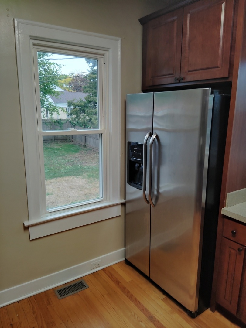 1406 Birch Road Homewood, IL 60430 - Photo 9 of 31 a kitchen with a refrigerator and cabinets
