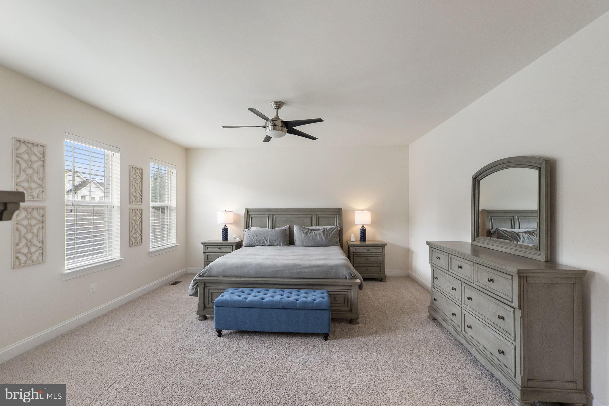 23902 Grapevine Ridge Terrace Clarksburg, MD 20871 - Photo 16 of 44 a bedroom with a large bed and a dresser