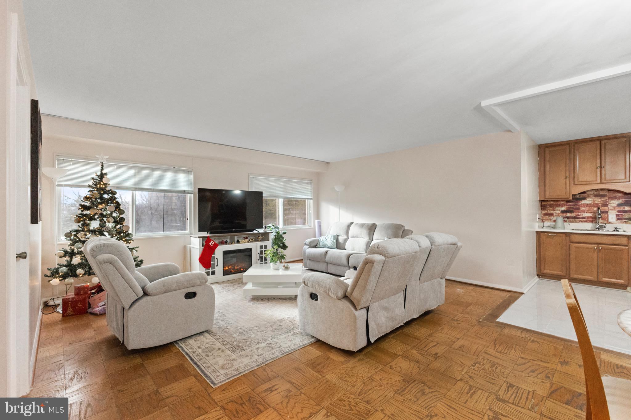 1111 University Boulevard West, Unit 313A Silver Spring, MD 20902 - Photo 1 of 20 a living room with furniture or flat screen tv and a fireplace
