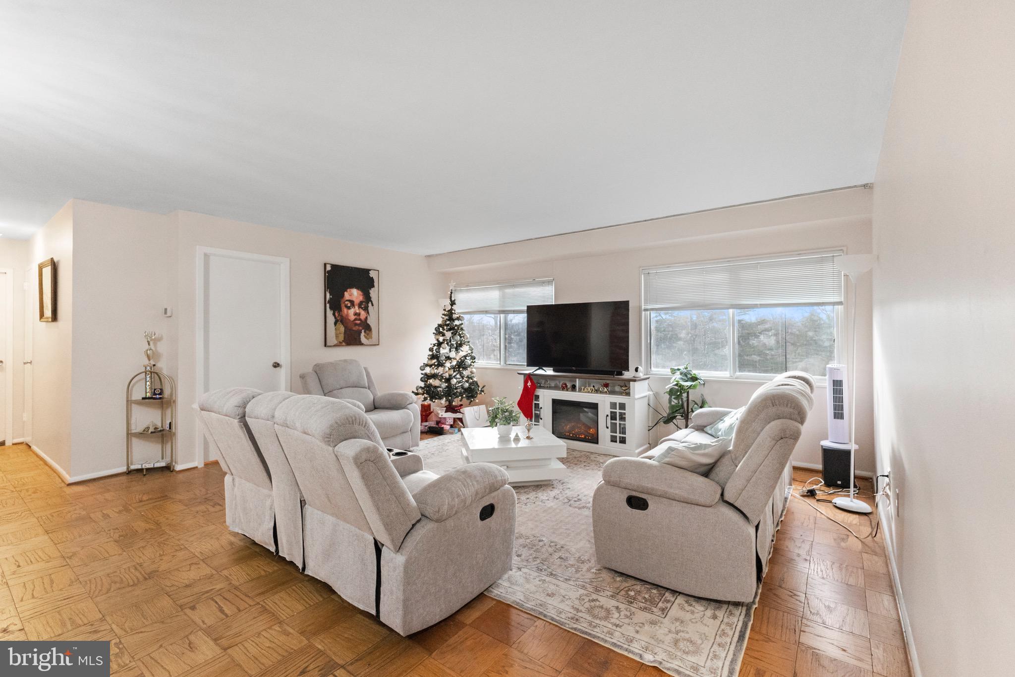 1111 University Boulevard West, Unit 313A Silver Spring, MD 20902 - Photo 3 of 20 a living room with furniture and a flat screen tv