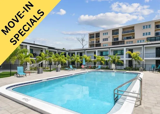 a view of a swimming pool with outdoor seating