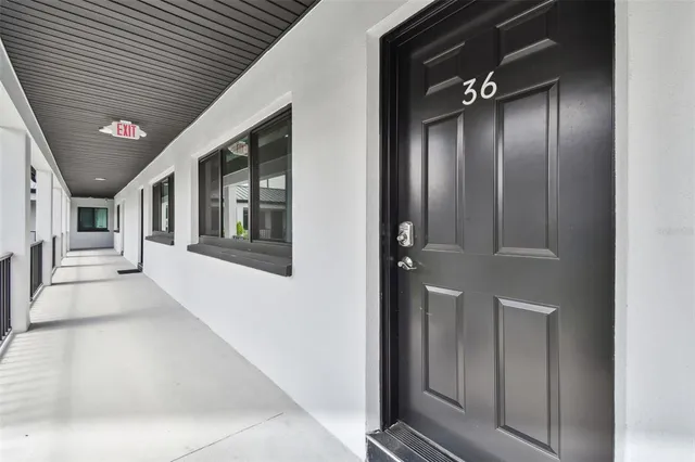 a view of a hallway with wooden shelves