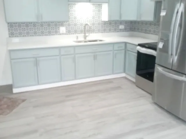 a kitchen with a sink cabinets and window
