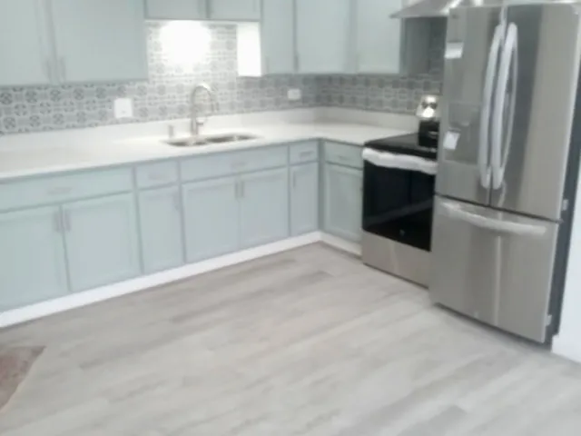 a kitchen with a sink cabinets and stainless steel appliances