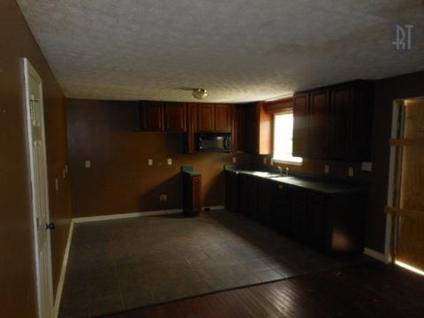 986 Maxwell Branch Road Cottontown, TN 37048 - Photo 9 of 13 a kitchen with refrigerator and cabinets