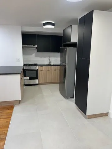 a kitchen with stainless steel appliances a refrigerator and a stove