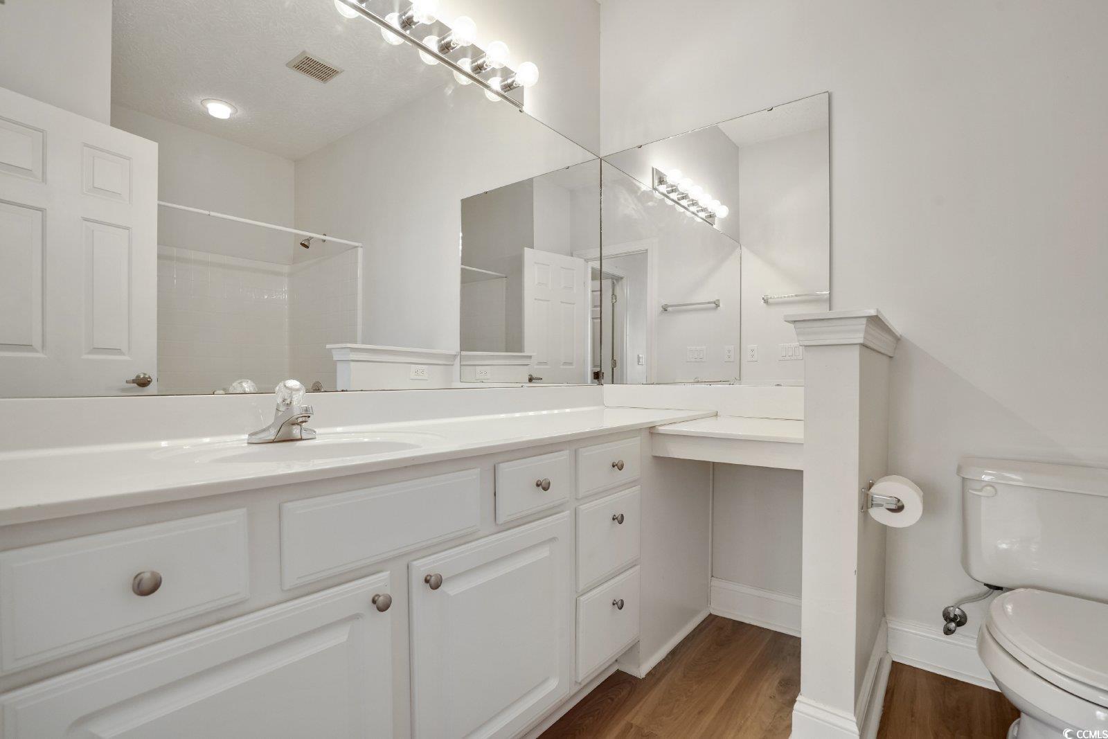 1113 Peace Pipe Place, Unit 204 Myrtle Beach, SC 29579 - Photo 13 of 27 Bathroom with wood finished floors, a shower, and vanity