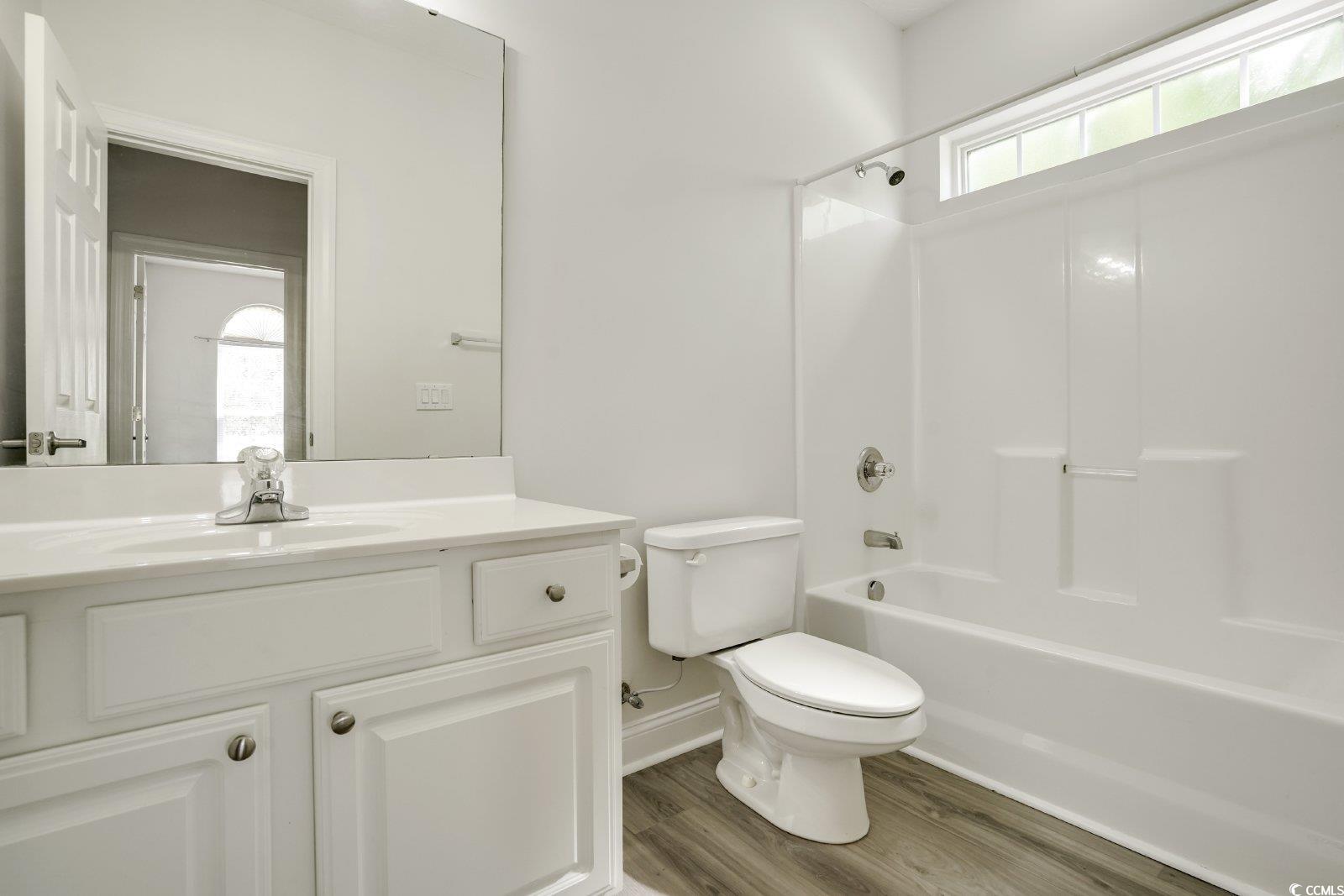 1113 Peace Pipe Place, Unit 204 Myrtle Beach, SC 29579 - Photo 18 of 27 Full bath featuring plenty of natural light, bathing tub / shower combination, wood finished floors, and vanity