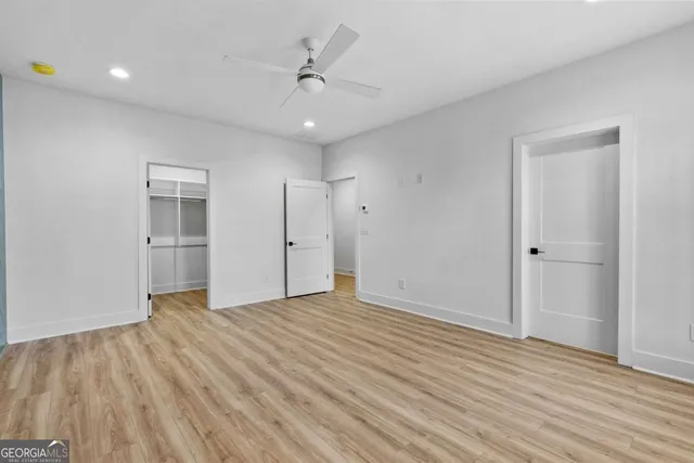 a bathroom with a white bath tub a sink and a mirror