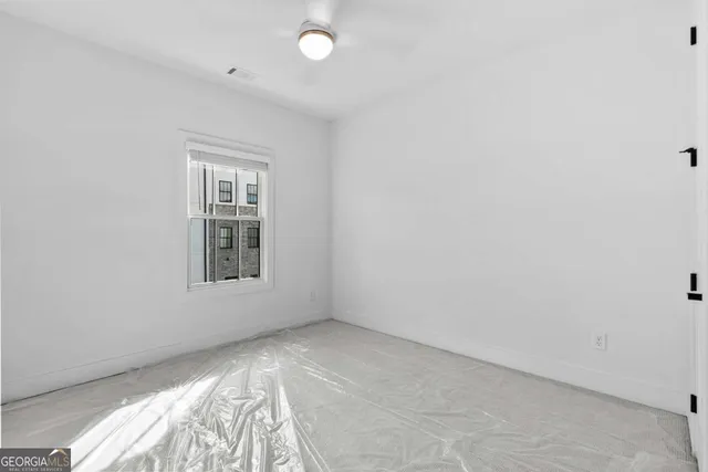 a view of an empty room with a window