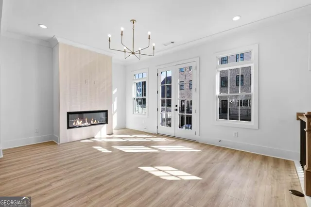 a view of a kitchen with wooden floor and a window