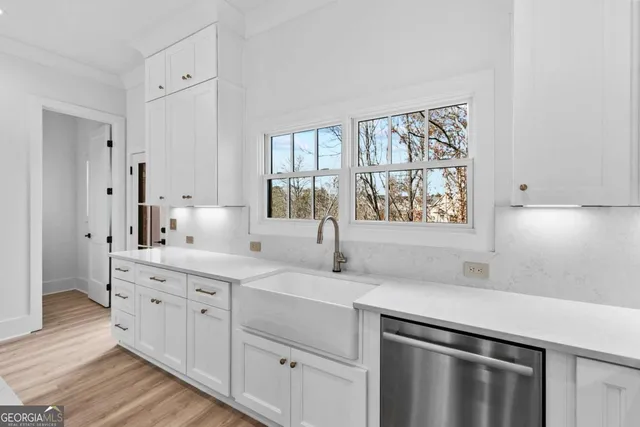 a kitchen with stainless steel appliances a stove a refrigerator and cabinets