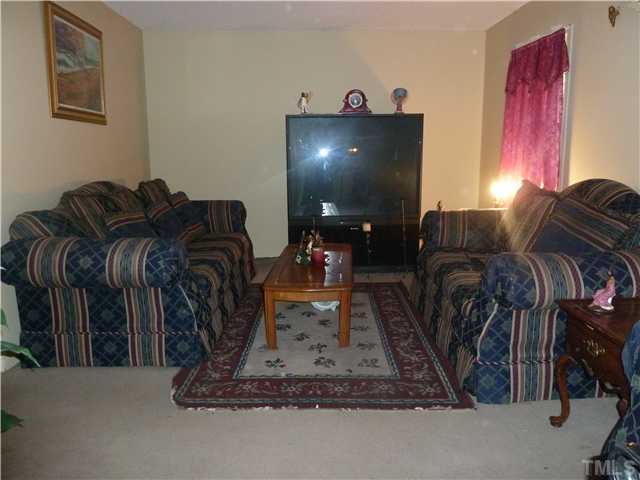 4204 Waterbury Road Raleigh, NC 27604 - Photo 5 of 7 a living room with furniture and a flat screen tv