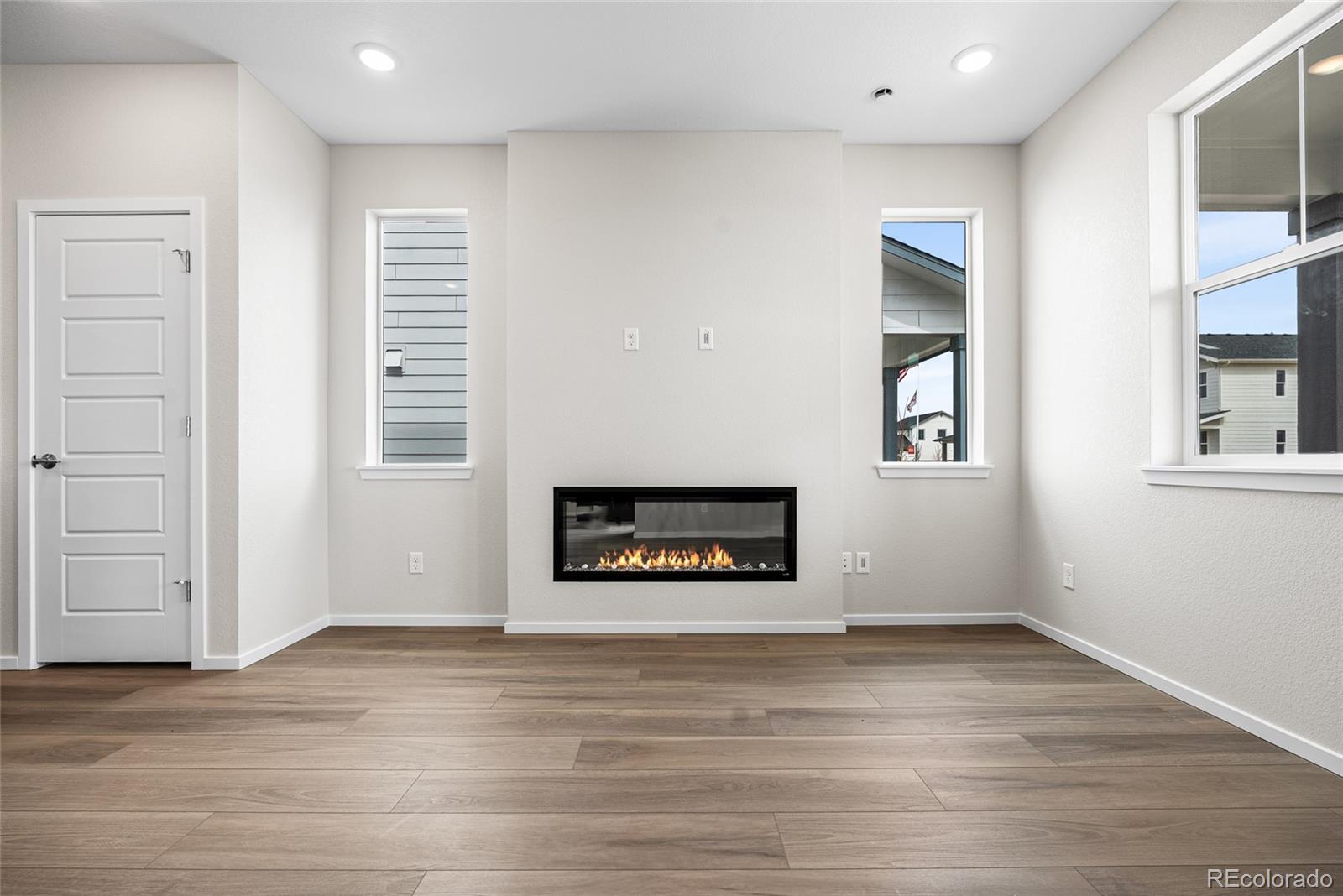 13181 Front Porch Lane Firestone, CO 80504 - Photo 12 of 34 an empty room with windows and entrance