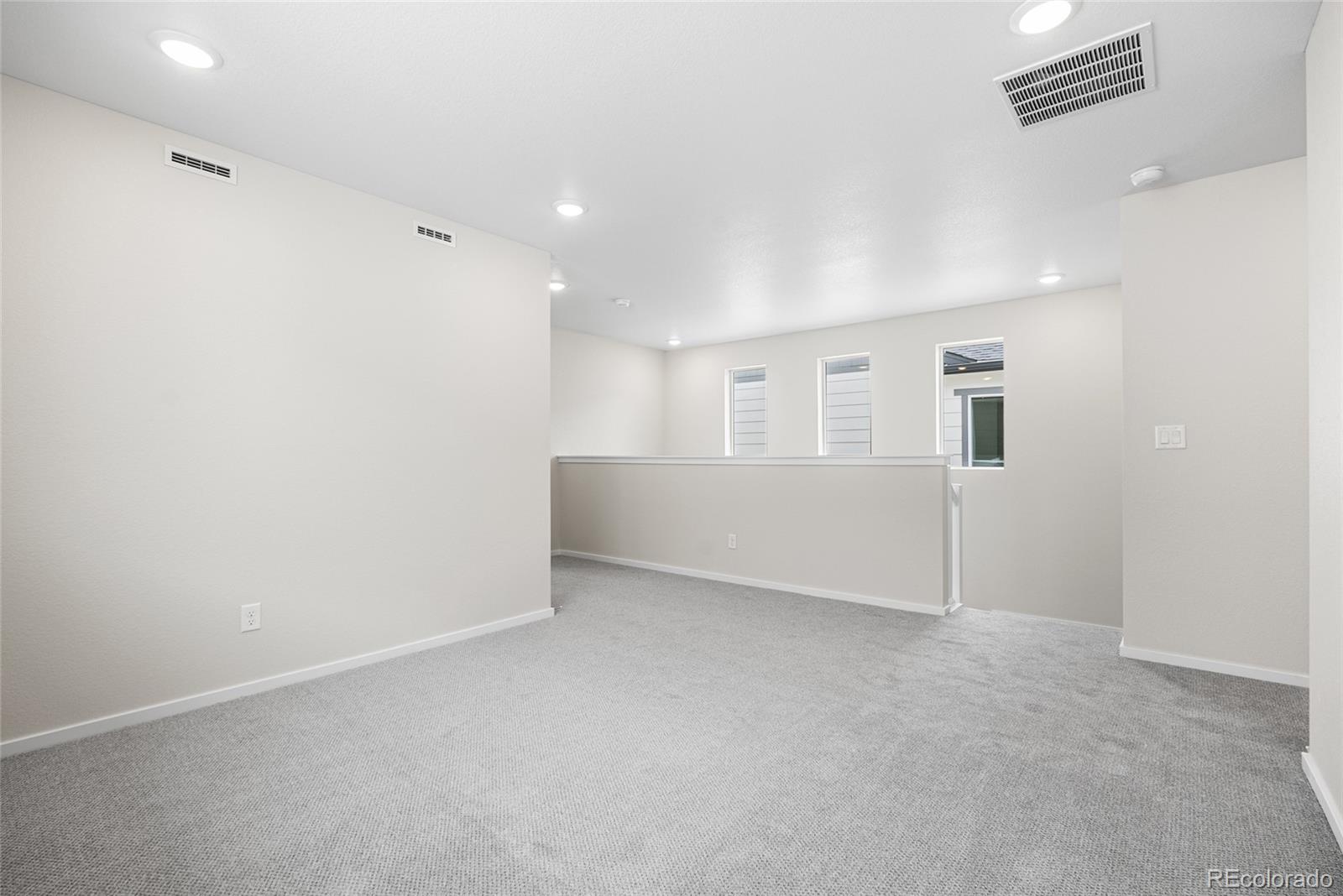 13181 Front Porch Lane Firestone, CO 80504 - Photo 18 of 34 an empty room with white walls and windows