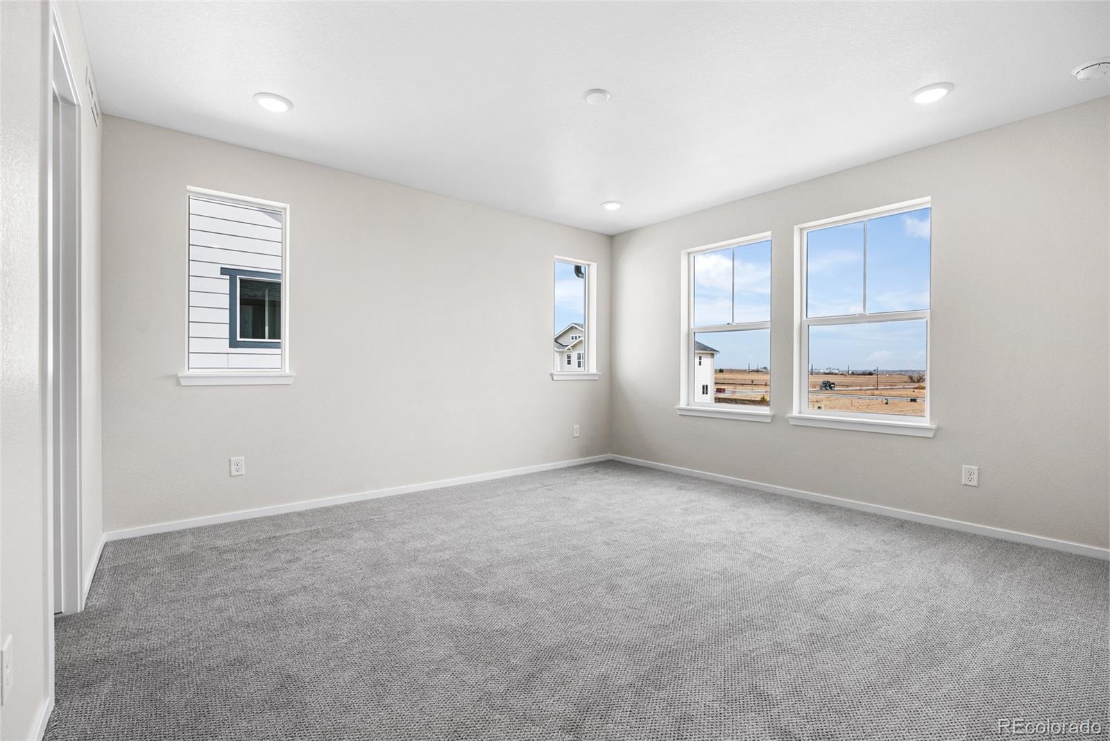 13181 Front Porch Lane Firestone, CO 80504 - Photo 19 of 34 an empty room with windows and closet