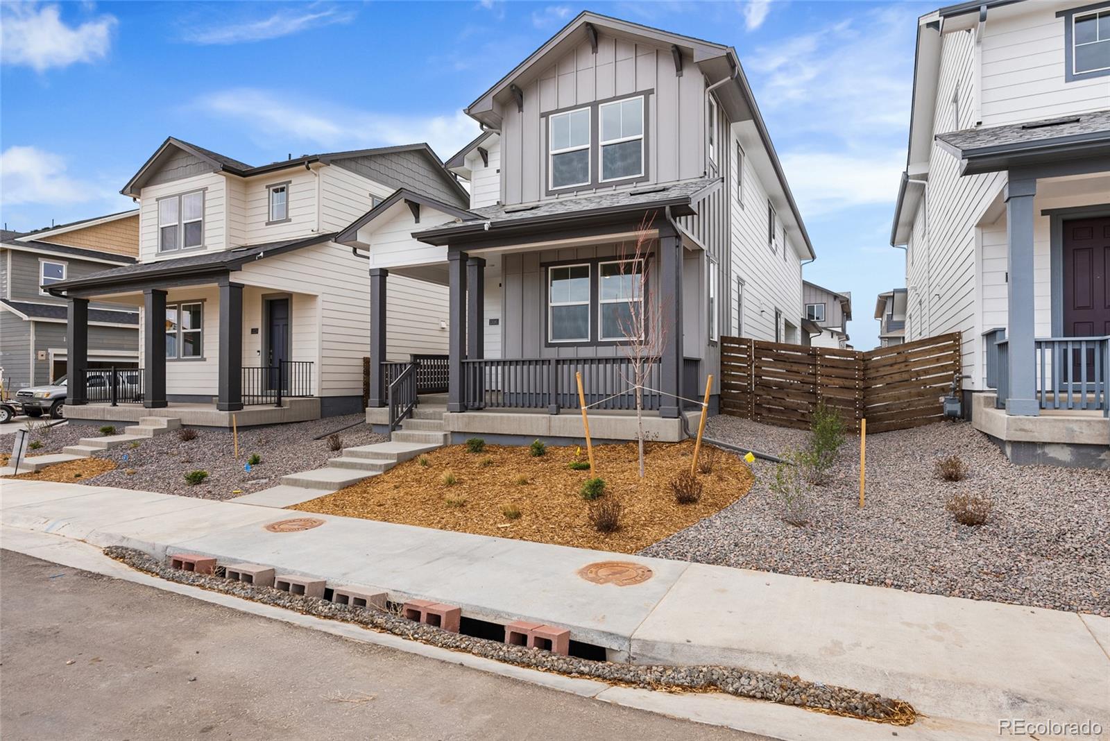 13181 Front Porch Lane Firestone, CO 80504 - Photo 2 of 34 a view of a white house with a swimming pool and sitting area