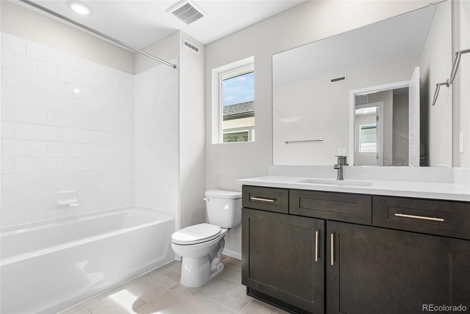 13181 Front Porch Lane Firestone, CO 80504 - Photo 21 of 34 a bathroom with a sink a toilet and a bathtub