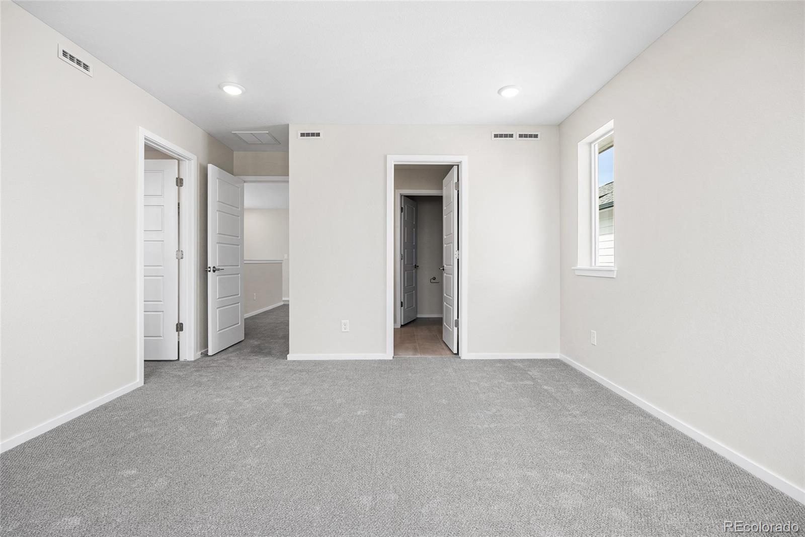 13181 Front Porch Lane Firestone, CO 80504 - Photo 28 of 34 a view of an empty room with closet and a window