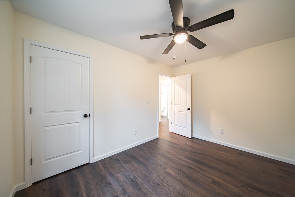 4410 Forrest Road Columbus, GA 31907 - Photo 27 of 30 an empty room with wooden floor ceiling fan and windows