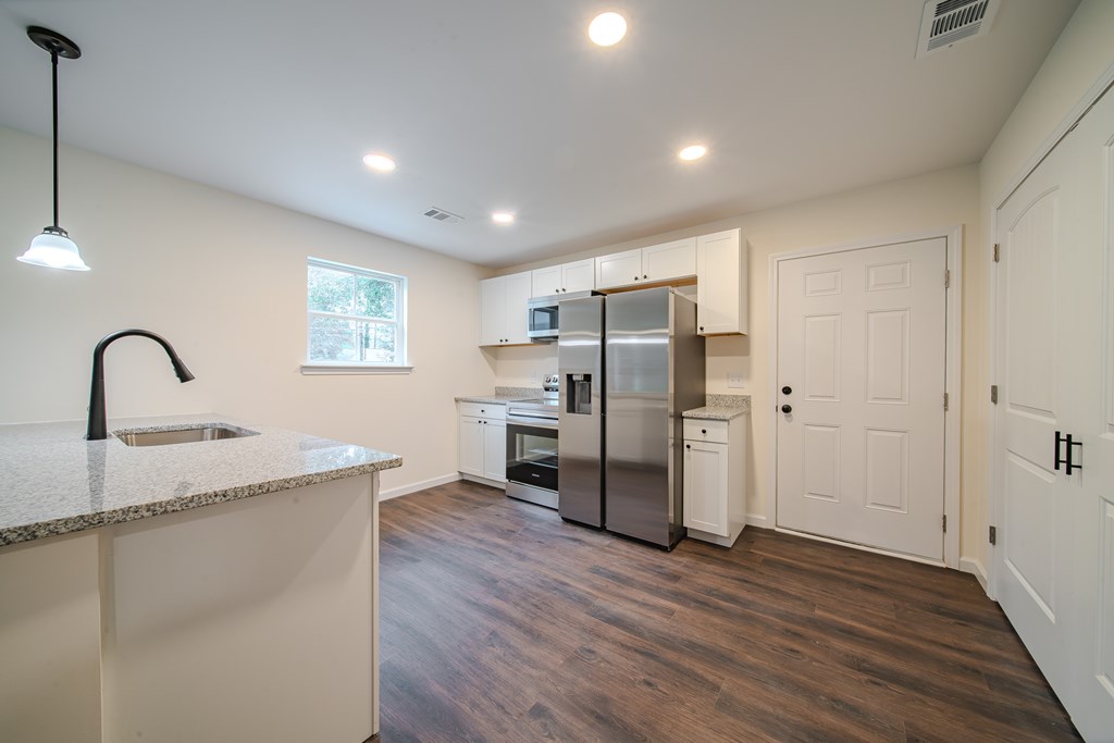 4410 Forrest Road Columbus, GA 31907 - Photo 10 of 30 a kitchen with a refrigerator sink and cabinets