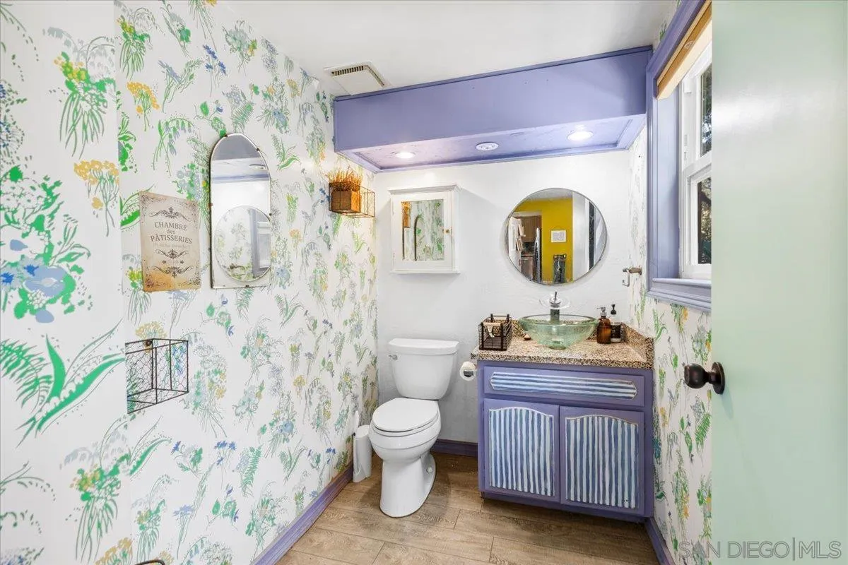 8621 Golf Drive Spring Valley, CA 91977 - Photo 21 of 41 a bathroom with a toilet a sink and a mirror