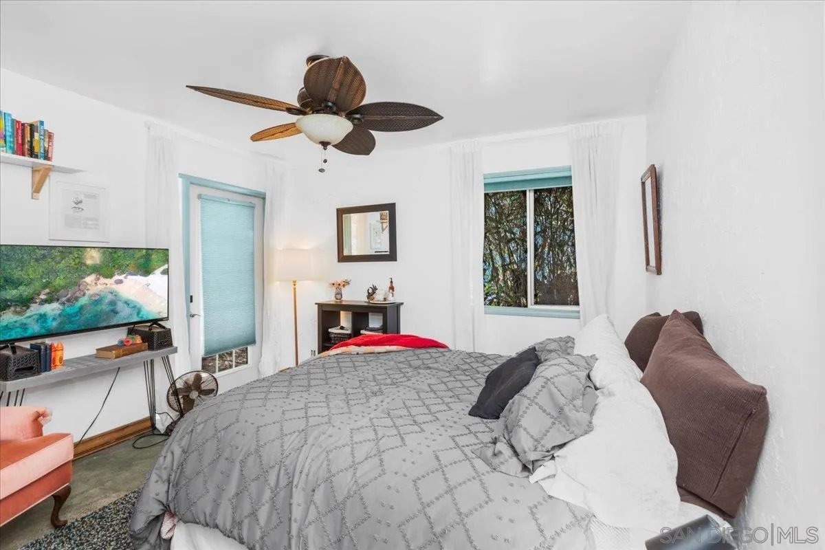 8621 Golf Drive Spring Valley, CA 91977 - Photo 30 of 41 a bedroom with a bed and a large window