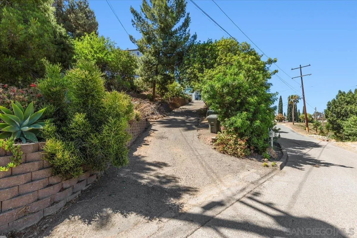 8621 Golf Drive Spring Valley, CA 91977 - Photo 3 of 41 a view of a pathway both side of white house