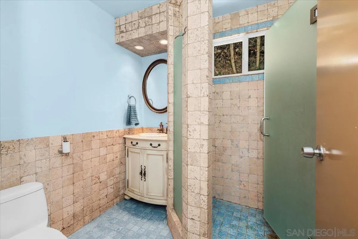 8621 Golf Drive Spring Valley, CA 91977 - Photo 31 of 41 a bathroom with a sink a toilet and a shower