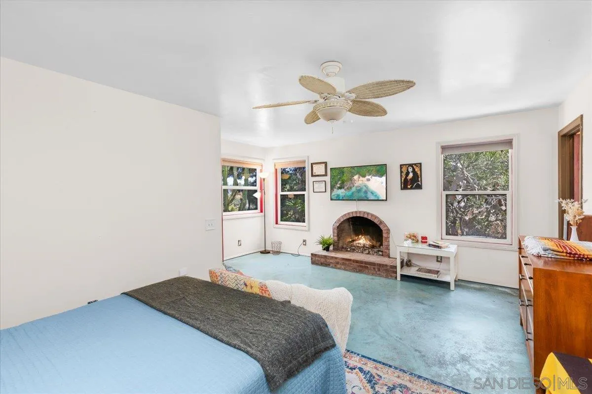 8621 Golf Drive Spring Valley, CA 91977 - Photo 32 of 41 a bedroom with a bed and a fireplace