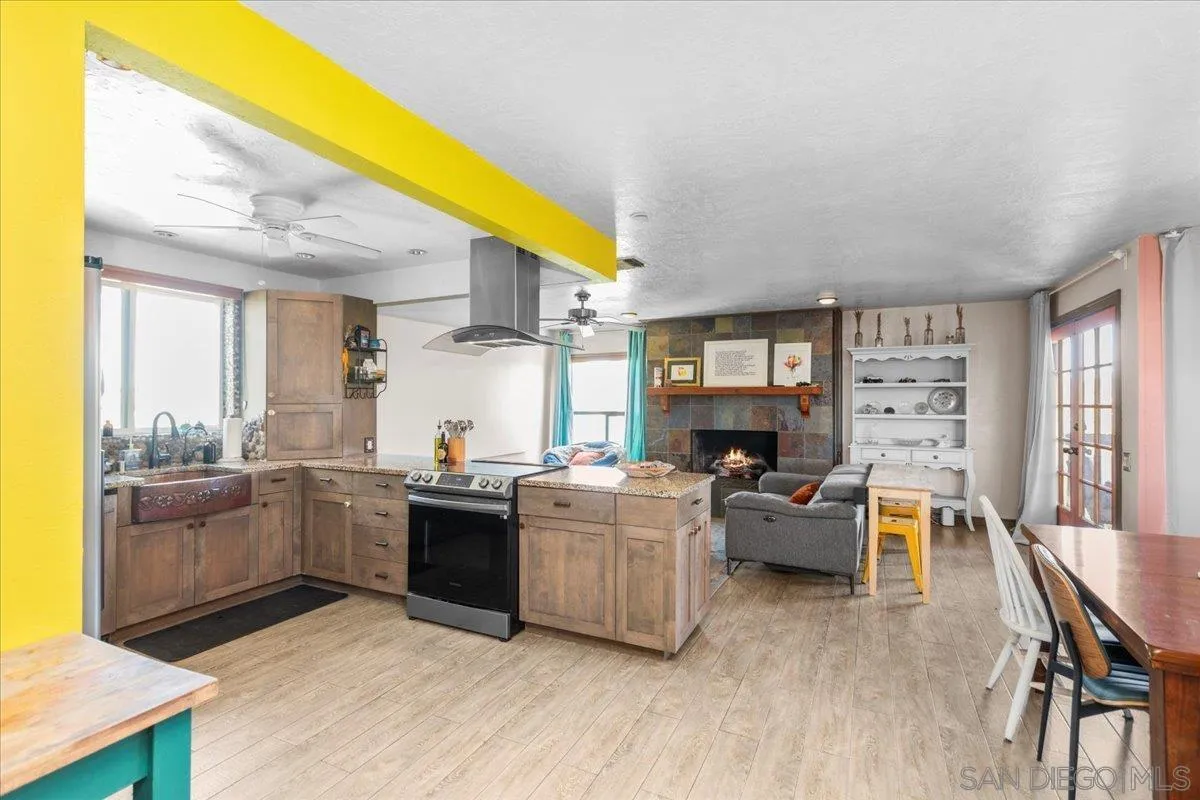 8621 Golf Drive Spring Valley, CA 91977 - Photo 7 of 41 a kitchen with kitchen island wooden floors and stainless steel appliances