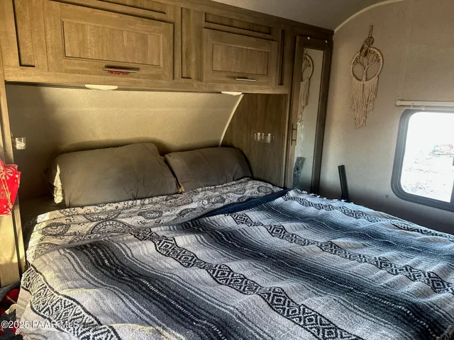 a bedroom with a bed and window